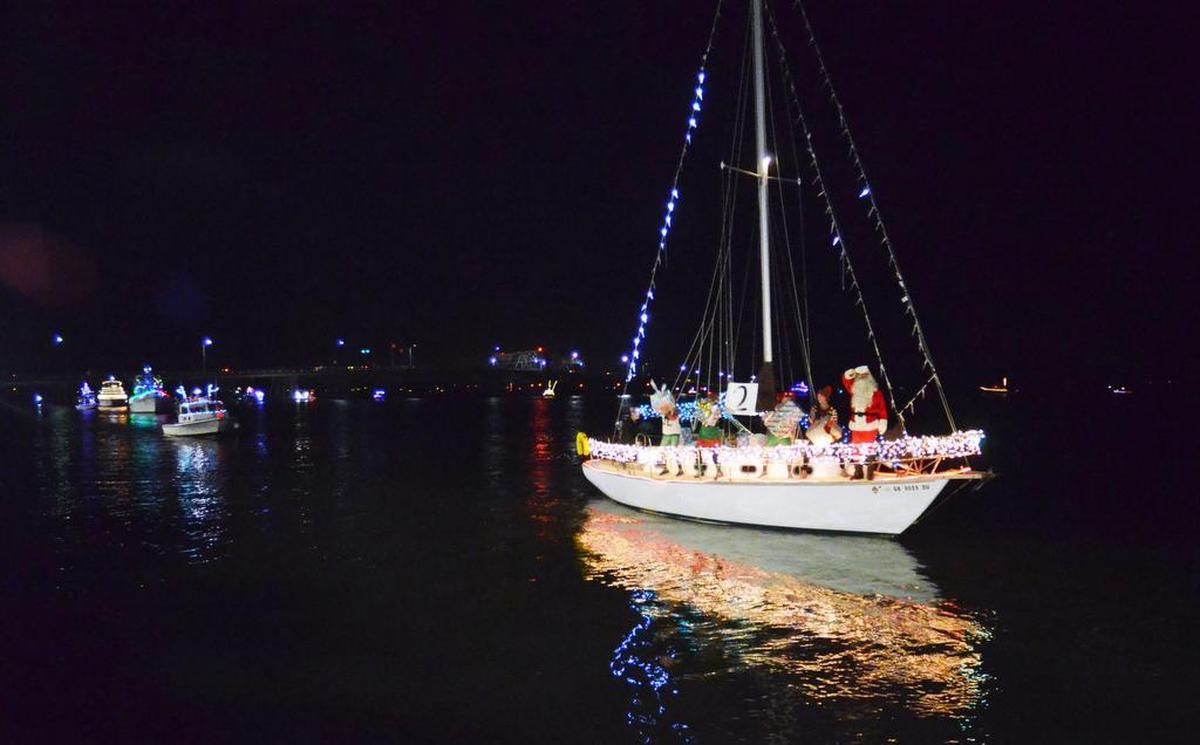Kamelita, captained by Jim Thomas, glides by during the Light Up the Night Boat Parade in Beaufort on Saturday. The vessel's theme was “Santa and the Enchanted Elf Experiment.”