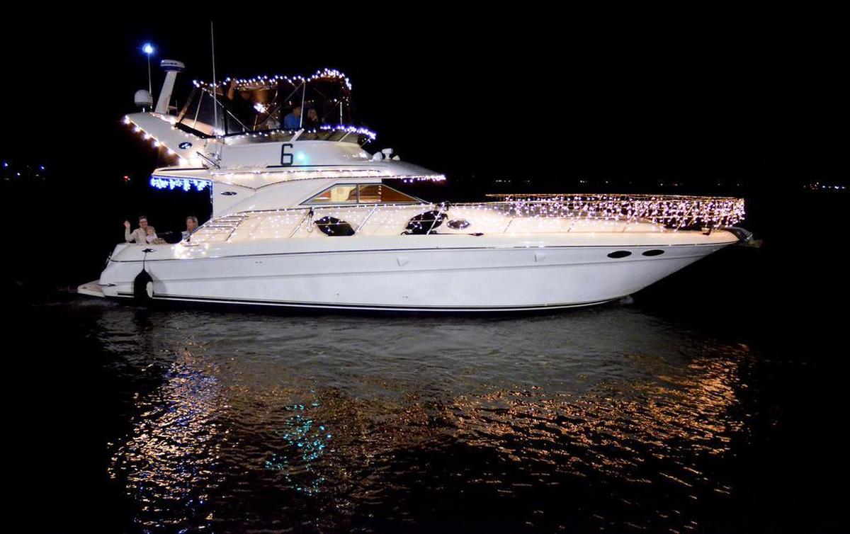 The boat Dream Weaver, captained by Bill Burcin, sparkles as it passes by the waterfront park during Saturday's Light Up the Night Boat Parade in Beaufort. The vessel's theme was “White Christmas.”