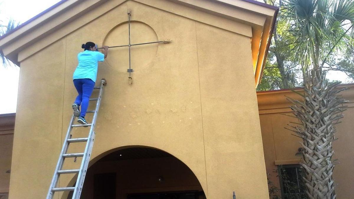 A woman works to clean the facade of a Lady’s Island restaurant Friday morning. The empty building will become home to Mexican restaurant La Nopalera.