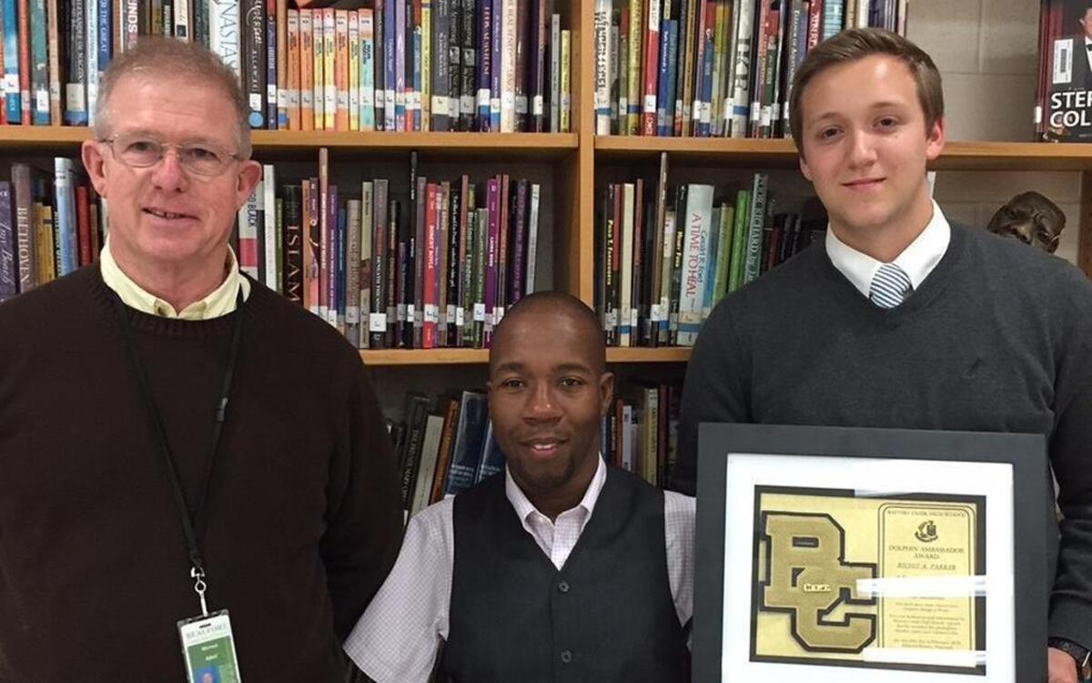 Battery Creek High School teacher Mike Allen, Richie Parker and BCHS student Garrett Morgan stand with a "Battery Creek Ambassador" award given to Parker in February.