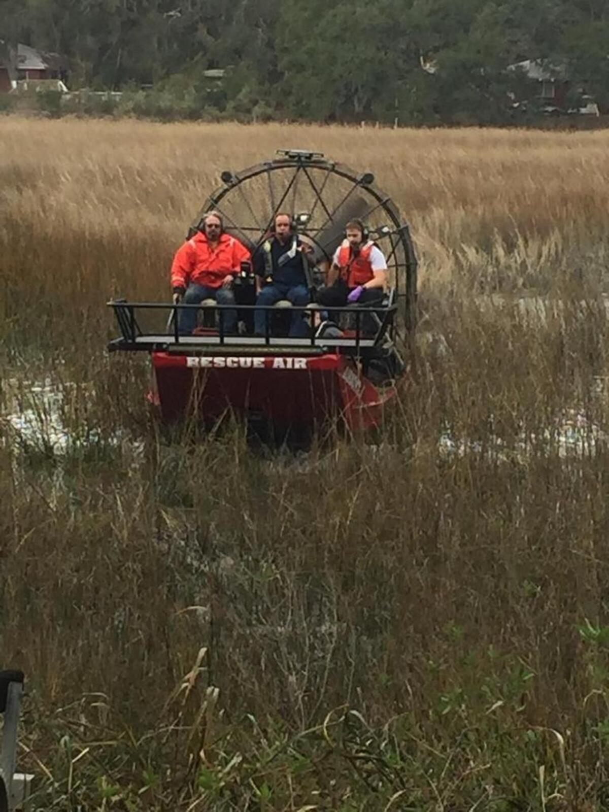Members of the Beaufort Water Search and Rescue service and a Beaufort/Port Royal firefighter rescue a man and his dog who had become stuck in pluff mud Jan. 16, 2017, off Sycamore Street, Beaufort.