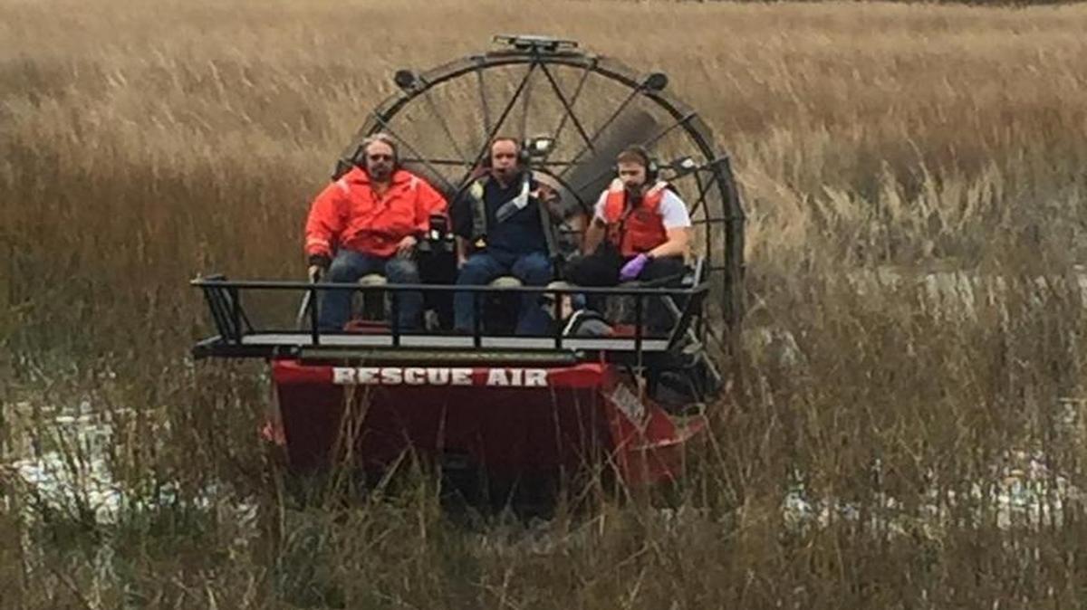 Members of the Beaufort Water Search and Rescue service and a Beaufort/Port Royal firefighter rescue a man and his dog who had become stuck in pluff mud Jan. 16, 2017, off Sycamore Street, Beaufort.
