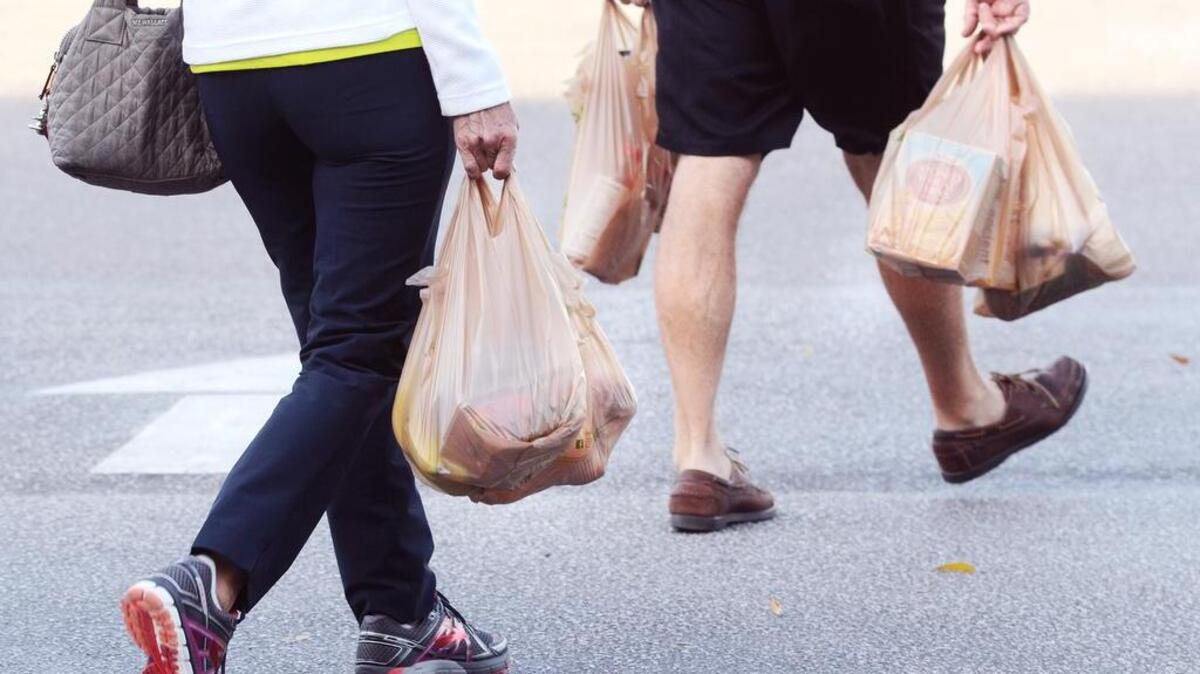 Shoppers leave the store with their groceries in plastic bags on Thursday. An online petition circulating in Beaufort is asking City Council to ban single-use plastic bags such as these.