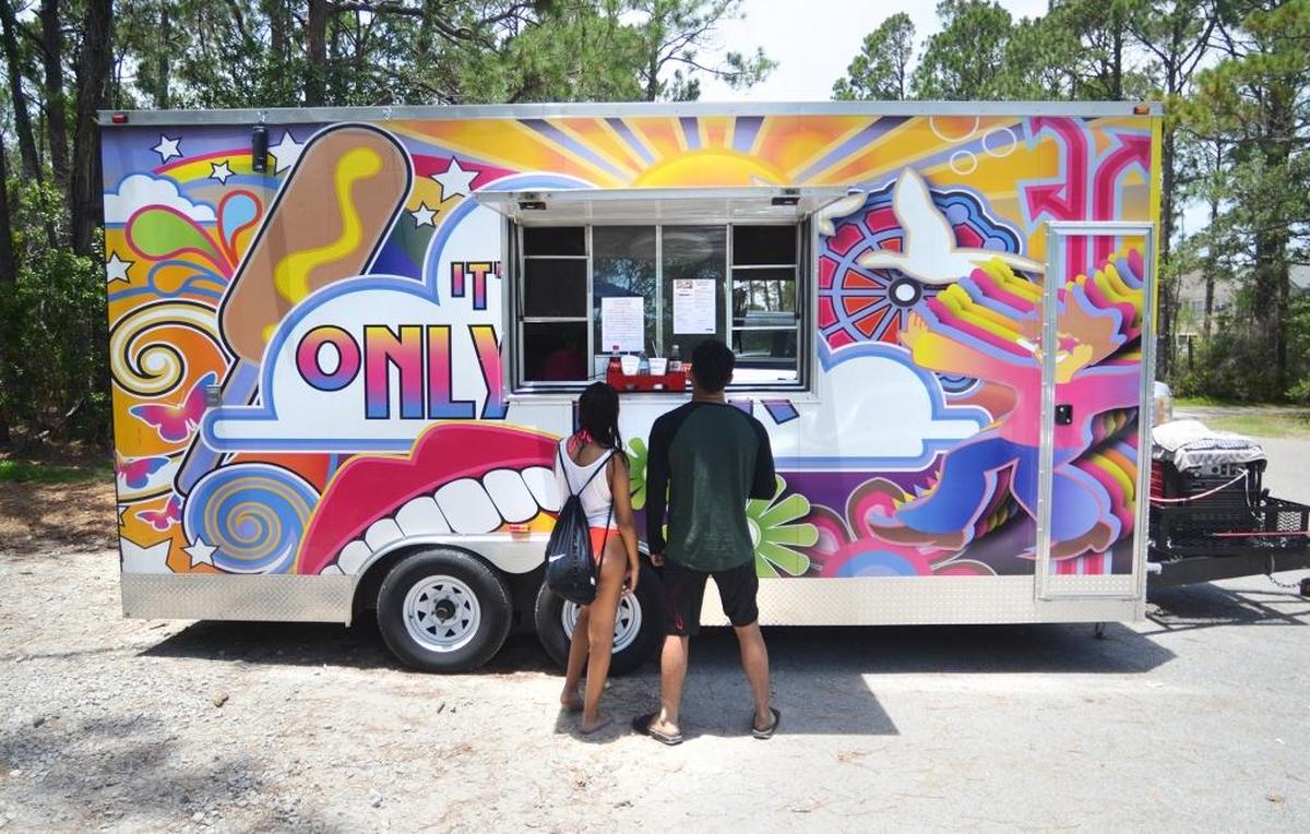 Beachgoers order food at the It’s Only Fair food truck in summer 2017.