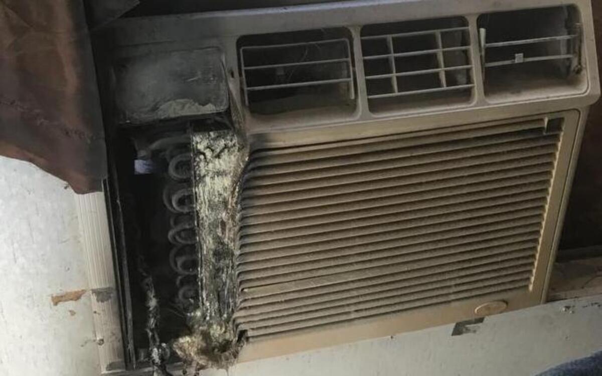An air conditioning unit caught fire at a Burton home Friday, August 18, 2017. Onlookers used a fire extinguisher to contain the blaze to the couch.