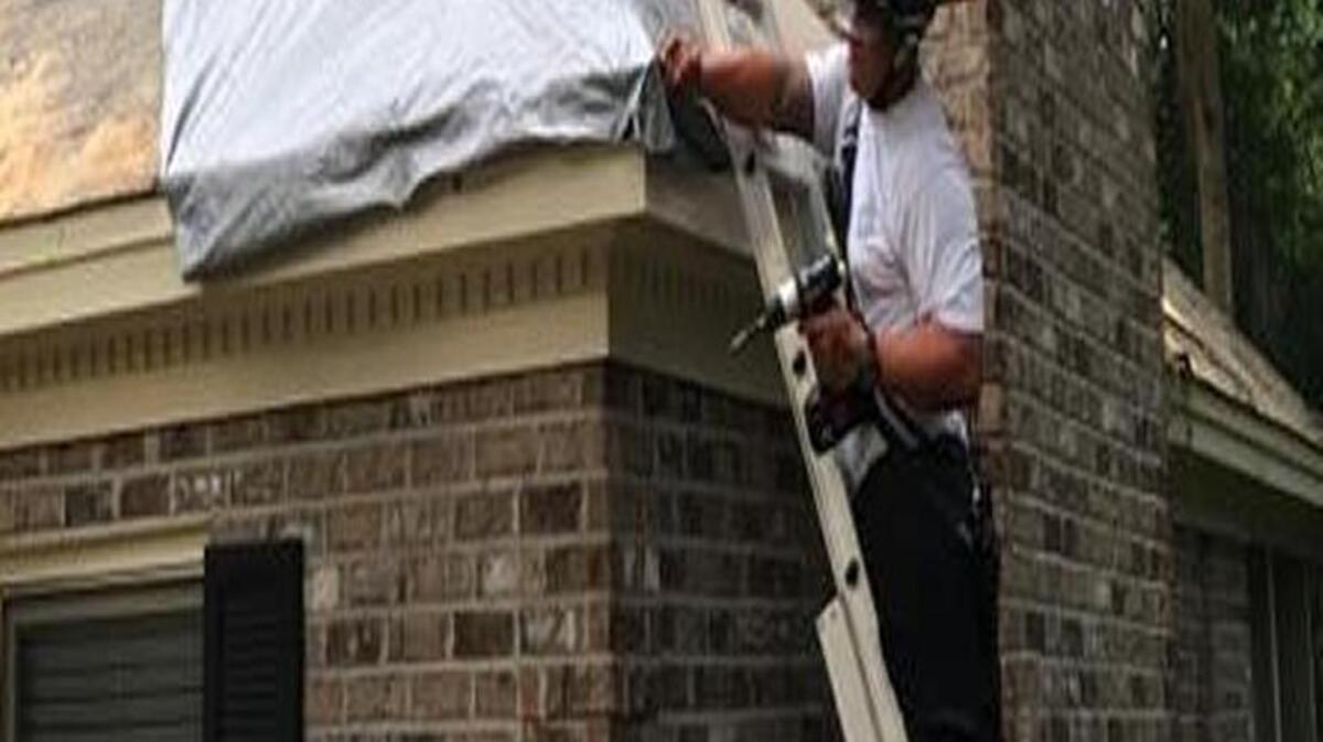 Beaufort firefighters help clear a tree and patch up the roof on a Joshua Circle home.