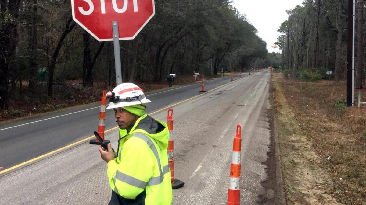 Devada Hines, with Preferred Materials, directs traffic on Sams Point Road on Lady's Island on Monday afternoon. About two miles of the northbound lane north of Brickyard Point Road past the Royal Pines area will be repaved.