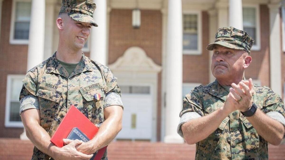 U.S. Marine Corps Brig. Gen Austin E. Renforth, right, the commanding general of Marine Corps Recruit Depot Parris Island and Eastern Recruiting Region, applauds Cpl. Miles Hogan during a ceremony on Aug. 24, 2017 on Parris Island, S.C. Hogan was awarded the Navy and Marine Corps medal for rescuing a man after a vehicle accident.