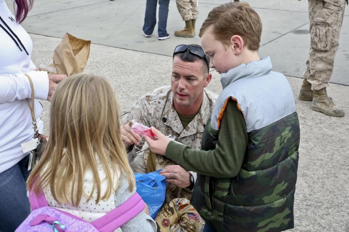 A Marine greets his family after returning from a seven month deployment, Nov. 21, aboard Marine Corps Air Station Beaufort. Marine All-Weather Fighter Attack Squadron 224 left for the deployment to support combat operations in the Central Command area of operations, May 8. The Marine is with VMFA(AW)-224.
