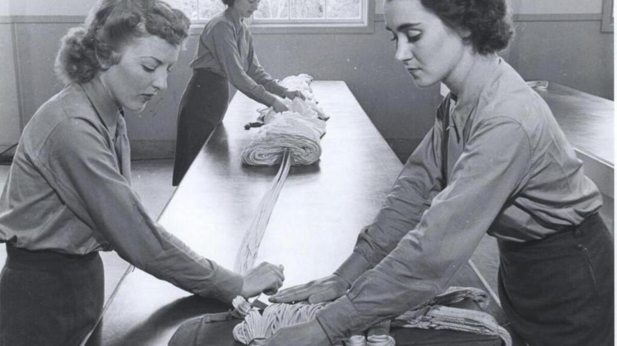 Women Marines are learning how to rig parachutes at the training school at Marine Corps Base Camp Lejeune, N.C.