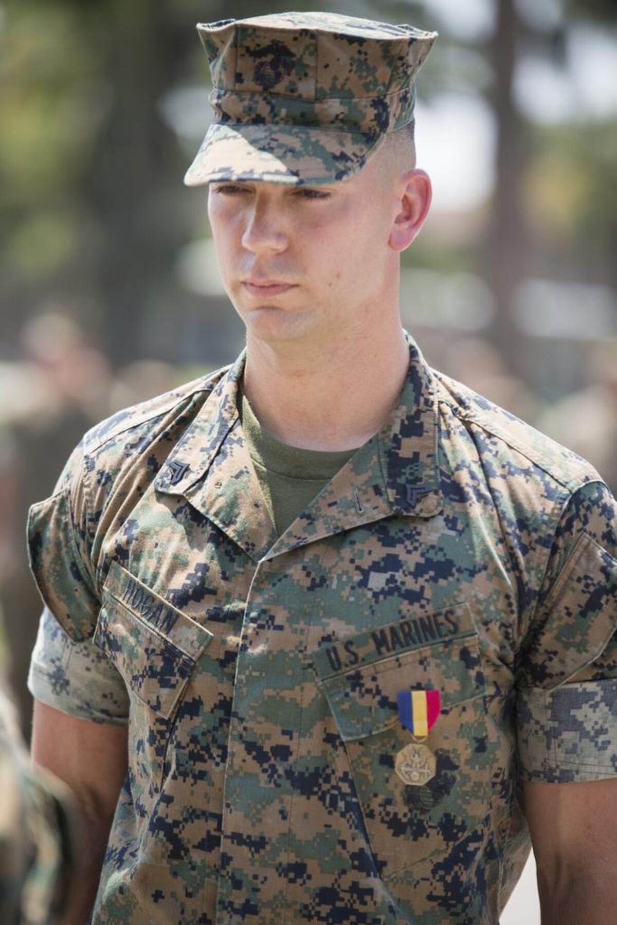 U.S. Marine Corps Cpl. Miles Hogan, a musician with the Parris Island Marine Band, Headquarters and Service Battalion, stands at attention after receiving the Navy and Marine Corps Medal during a ceremony on Aug. 24, 2017, at Marine Corps Recruit Depot Parris Island, S.C. In February of 2016, Hogan rescued a man after a vehicle accident.