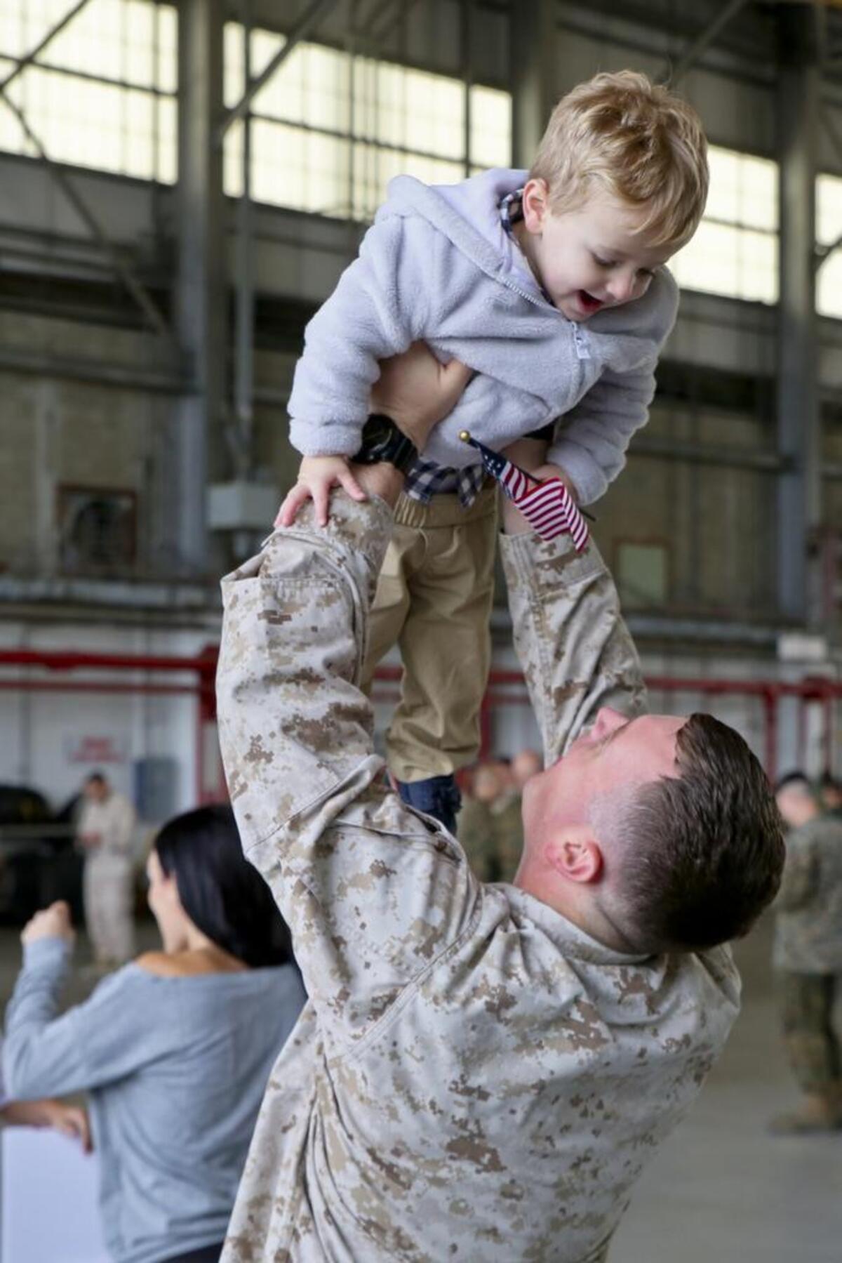 A Marine greets his family after returning from a seven month deployment, Nov. 21, aboard Marine Corps Air Station Beaufort. Marine All-Weather Fighter Attack Squadron 224 left for the deployment to support combat operations in the Central Command area of operations, May 8. The Marine is with VMFA(AW)-224.