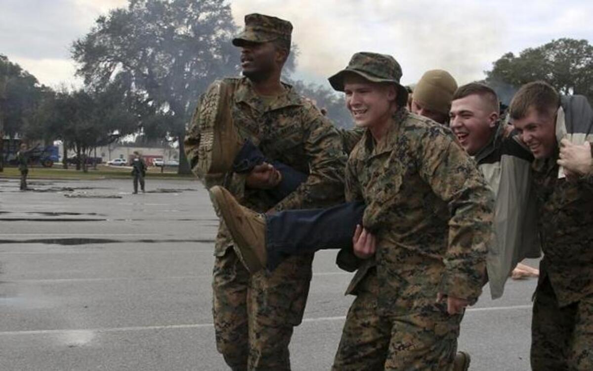 Marines with Headquarters Company, Headquarters and Service Battalion at Marine Corps Recruit Depot Parris Island, execute the "chair" buddy carry to move simulated victim away from a simulated terrorist attack during an anti-terrorism exercise on Feb. 5, 2015. The simulated attack was held to test the actions and reaction times of the first responders as well as the Marines aboard the depot.