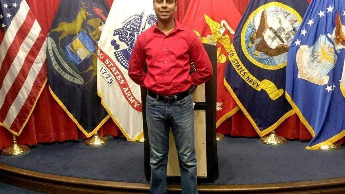 In this photo from Facebook, Raheel Siddiqui poses in front of flags representing the various branches of the U.S. military. The Taylor, Michigan, native died March 18, 2016, during Marine Corps recruit training on Parris Island. His death was investigated by the Corps and the Naval Criminal Investigative Service.