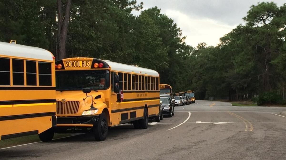 Minutes before Hilton Head Island public middle and high school dismissal, a line of buses and cars stretches a half mile down Wilborn Road on September 21, 2016.