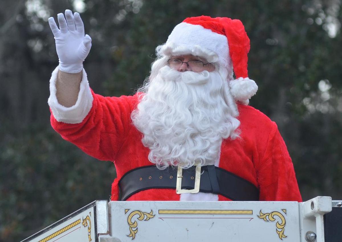 Santa waves to the crowd from atop a fire truck during Sunday’s Beaufort Christmas Parade.