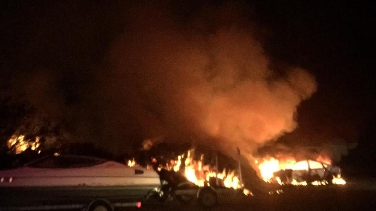 A car fire at a St. Helena boat landing sparked a brush fire that firefighters battled almost two hours early Friday morning.