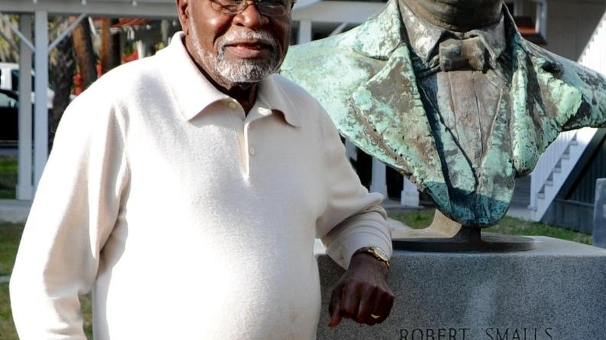Andrew Billingsley stands next to the bust of Robert Smalls at Tabernacle Baptist Church in Beaufort.