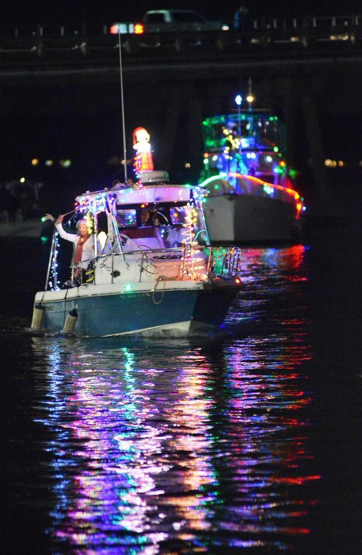 The Miss Mae, piloted by Steve Mendoza, cruises past during the Light Up the Night Boat Parade in Beaufort on Saturday night. The boat’s theme was “Snoopy Christmas.”