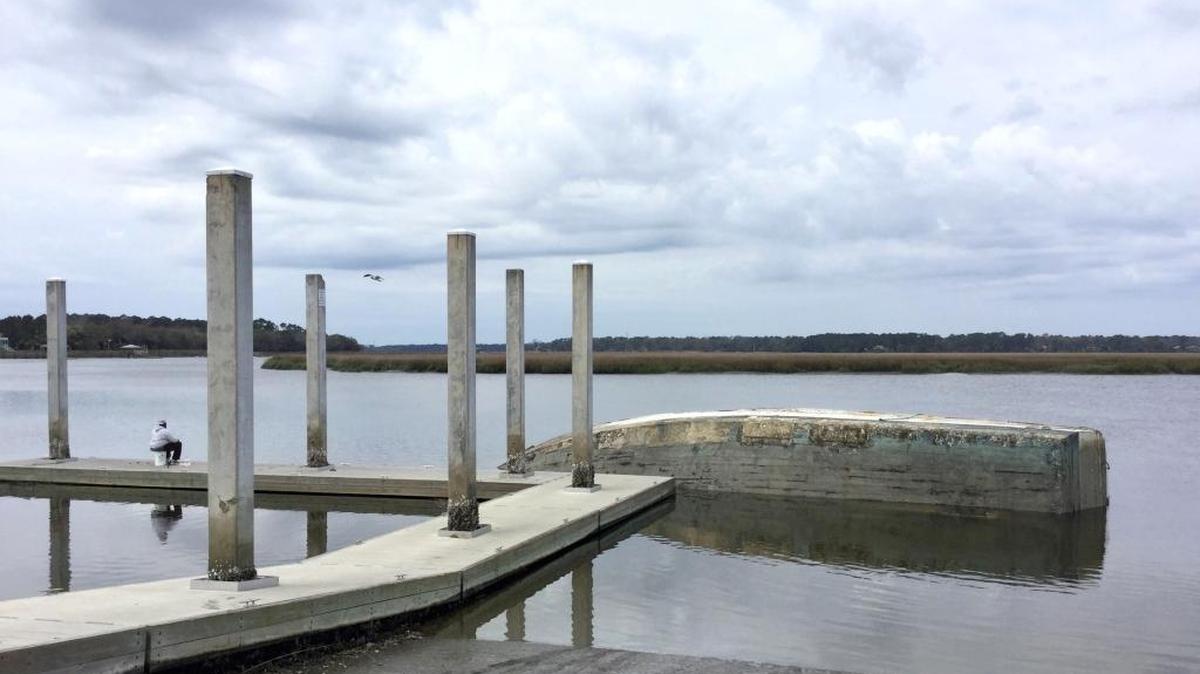 A half-sunken shrimp boat partially blocks access to Jenkins Creek from the Eddings Point Boat Landing in St. Helena Island on Monday.