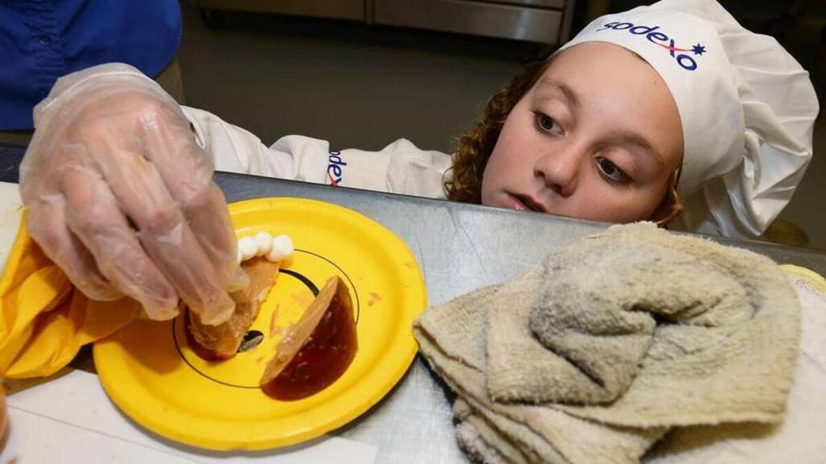 Ella Smiley of Hilton Head Island touches up her dish during the 2015 Future Chef competition.