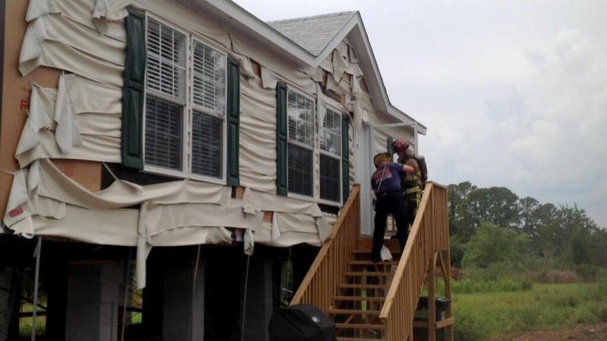 Burton Fire District firefighters at a home at Trask Parkway and Indol Road the afternoon of May 12, 2016. A yard debris fire destroyed a shed and damaged the home by melting the vinyl siding and, according to Lt. Bobby Davidson, melting a window.