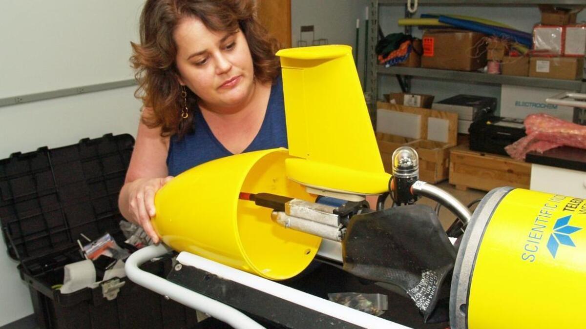 UGA Skidaway Institute of Oceanography researcher Catherine Edwards assembles the tail cone assembly of a glider.
