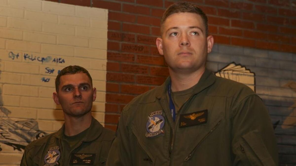 Capt. Taylor Zehrung , left, and Capt. Robert Reddy, right, watch the commanding officer of Marine Fighter Attack Training Squadron 501 during a patching ceremony aboard Marine Corps Air Station Beaufort on Friday. The Marines are the first pilots to be trained on the F-35B Lightning II straight out of flight school. During the ceremony, the pilots received the patches of their new unit, Marine Fighter Attack Squadron 121.