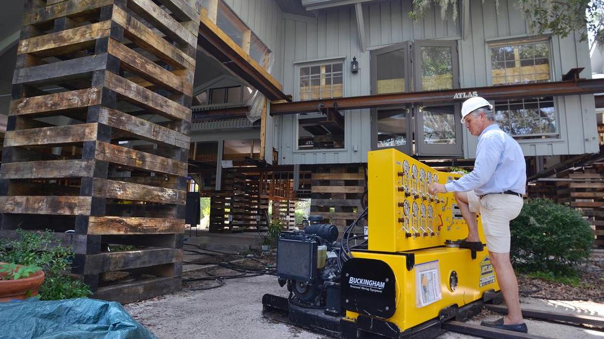 Lifting a home is one tactic property owners can take to reduce flood insurance rates. Mark Creamer, owner of Atlas Lifting and Demo, uses the Unified Jacking System's control panel to run all 20 hydraulic jacks used in the lift.
