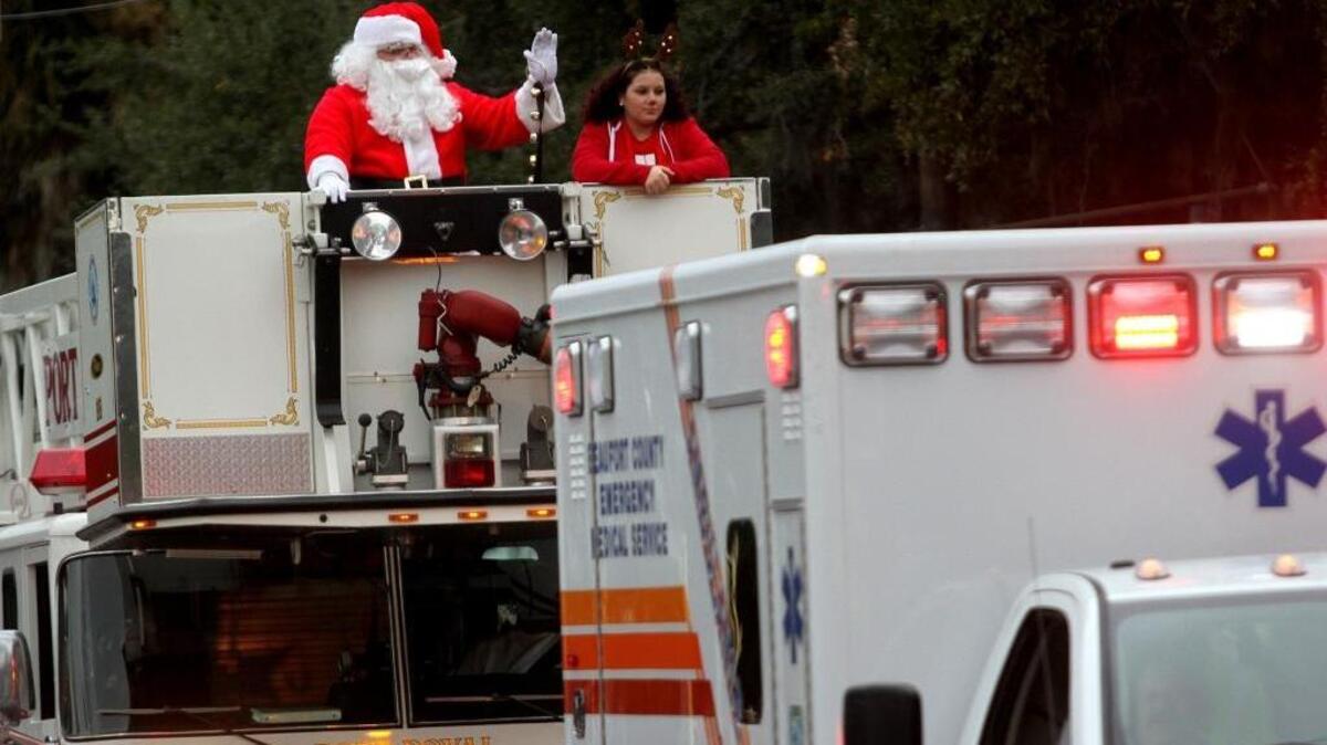 Santa rides in the parade on top of one of the fire trucks during the 2016 Beaufort Christmas Parade on Sunday on Boundary Street in Beaufort.