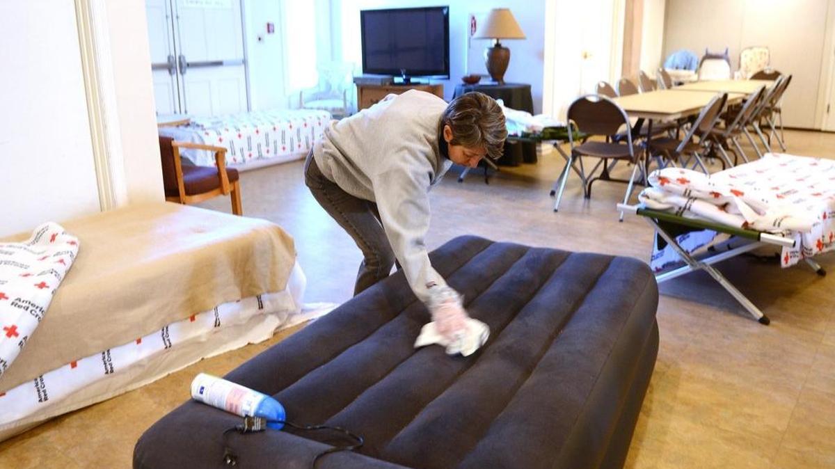 File Photo: Nancy Pratt, a volunteer from Port Royal, wipes down one of the beds with disinfectant Jan. 9, 2017, while getting ready for the final night of the warming shelter located at Sea Island Presbyterian Church on Lady’s Island.