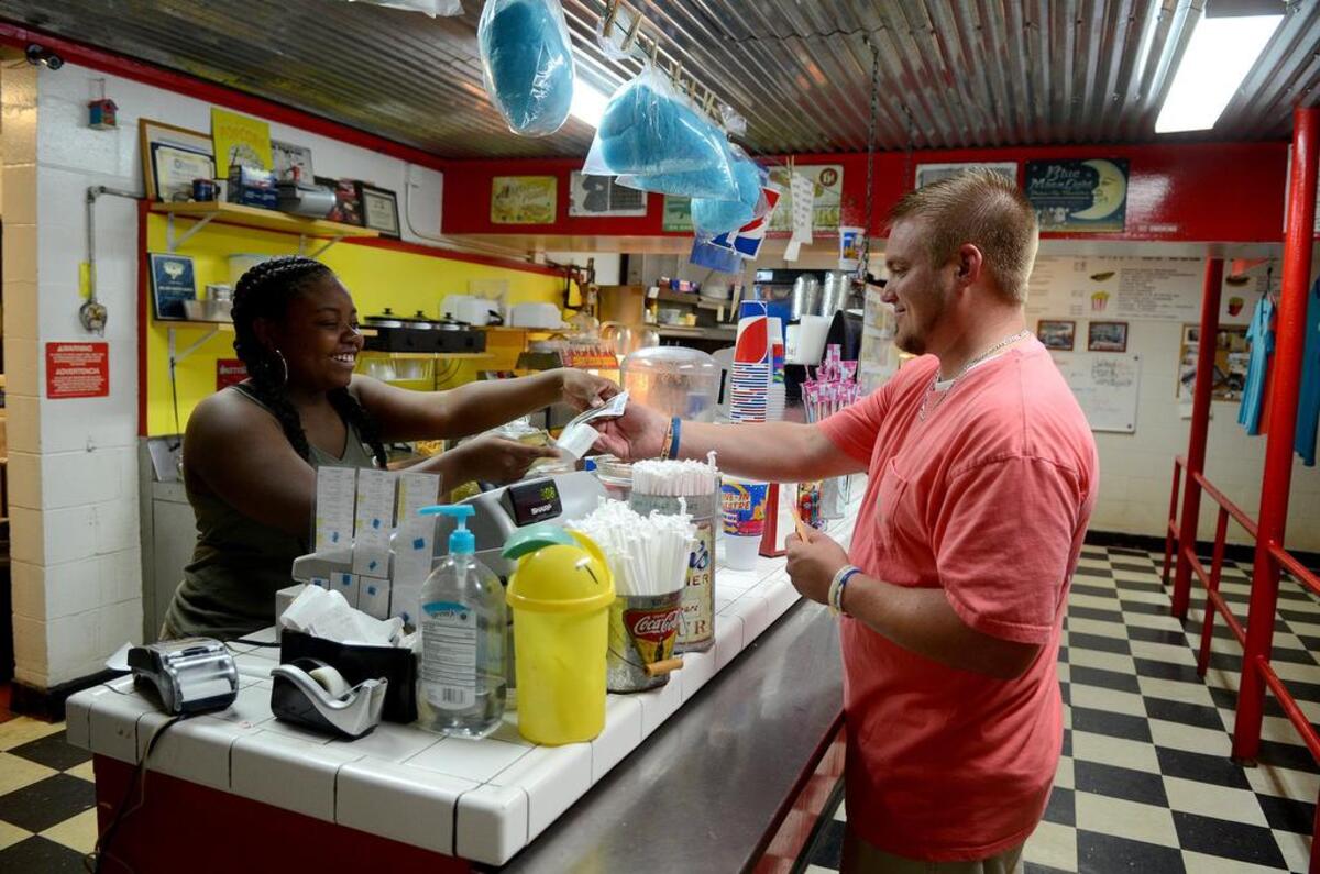 Jimmy Brown, right, of Rincon, Ga. purchases concessions for his family before the movie on Sunday, October 2, 2016, at the Hwy 21 Drive-In in Beaufort.