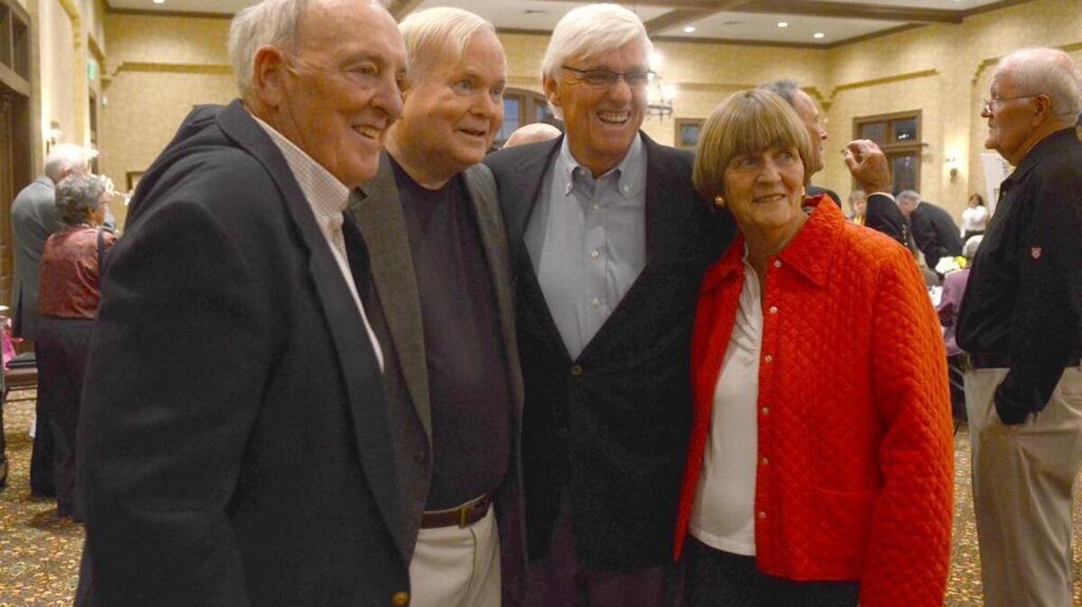 Ed O'Brien, left, Pat Conroy, center left, and Bobby Cremins, center right, and his wife Carolyn Cremins, right, smile for a photo during an event to raise money for the new athletic and arts center for John Paul II Catholic School at the Hampton Hall Clubhouse in Jan. 2015 in Bluffton, SC.