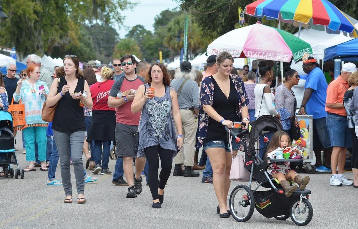 Festivalgoers stroll down Paris Avenue during OctoPRfest in Port Royal on Saturday.