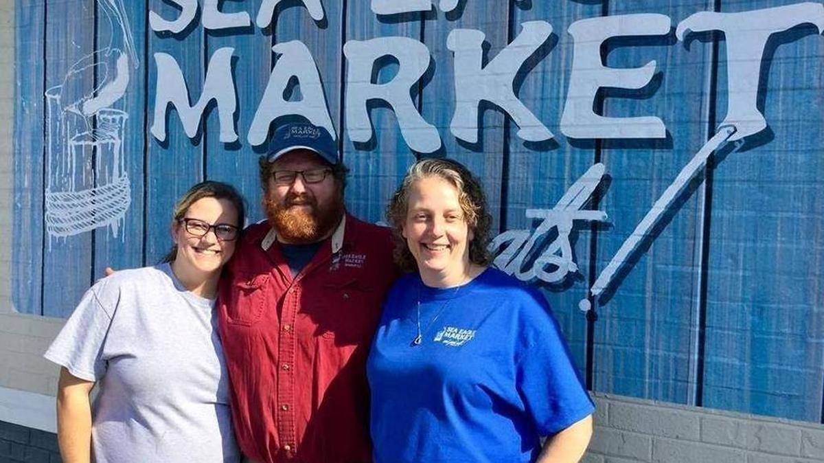 Craig Reaves, center, poses with, from left, his daughter, Melena Argetsinger, and wife, Jana Reaves, at the opening of Sea Eagle Market, the family business that opened in a new location on Boundary Street in November. Craig Reaves helped a Beaufort County Sheriff’s Office deputy during a scuffle in the parking lot in December. Josh Mitelman jmitelman@islandpacket.com