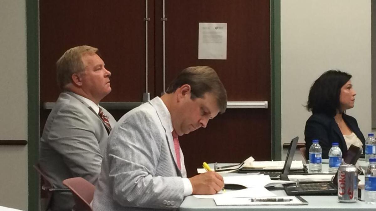 Superintendent Jeff Moss, left, sits next to district attorney Drew Davis during a Beaufort County school board meeting June 16, 2016.