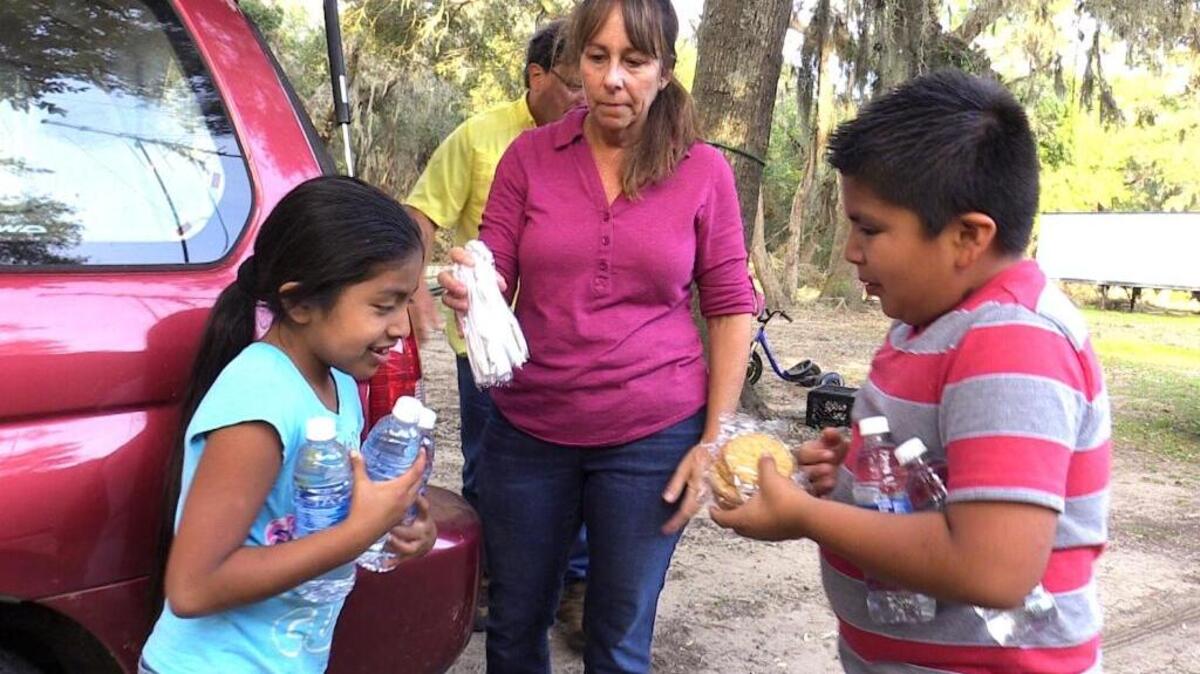 Xenia Perez-Pedro, 7, and her brother Elder, 9, of St. Helena Island, the children of migrant workers, juggle part of a food delivery brought to the family by Amy and Joe Taylor, of Waters Edge United Methodist Church on Lady’s Island, Oct. 14, 2016.