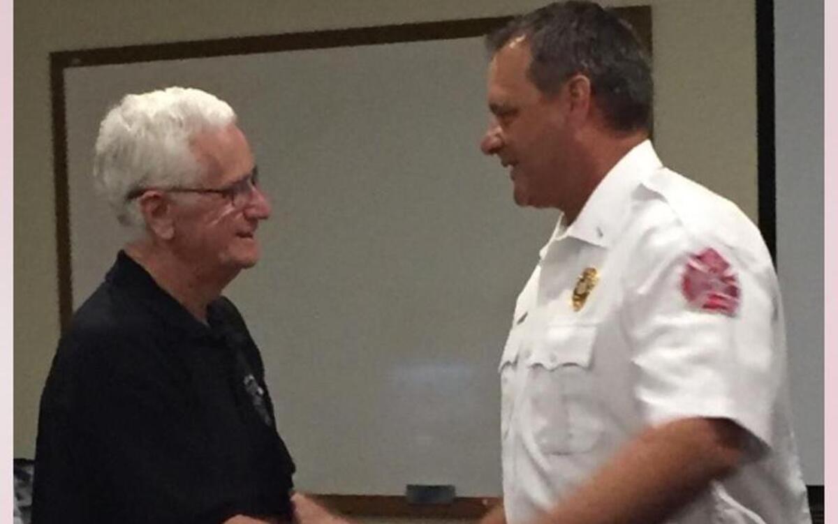 Lt. Scott Sampson shakes hands with his father during a ceremony for Scott’s promotion within Lady’s Island-St. Helena Island Fire District.