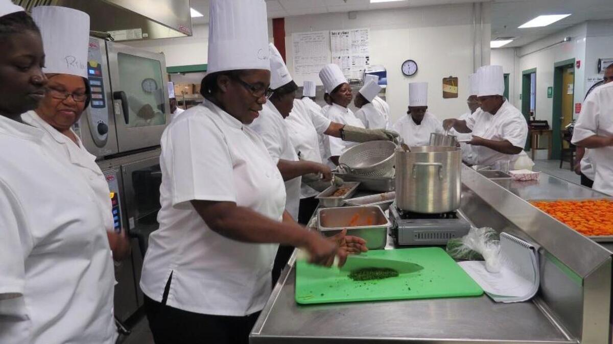 Carol Walker, center, chops parsley during the Jasper County School District's culinary training in early August.