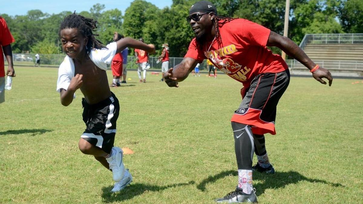 Kansas City Chiefs’ Ron Parker encourages one of the athletes to run faster during a drill Saturday morning, the second day of the third annual Ron Parker Football Camp at Beaufort Middle School in Beaufort.