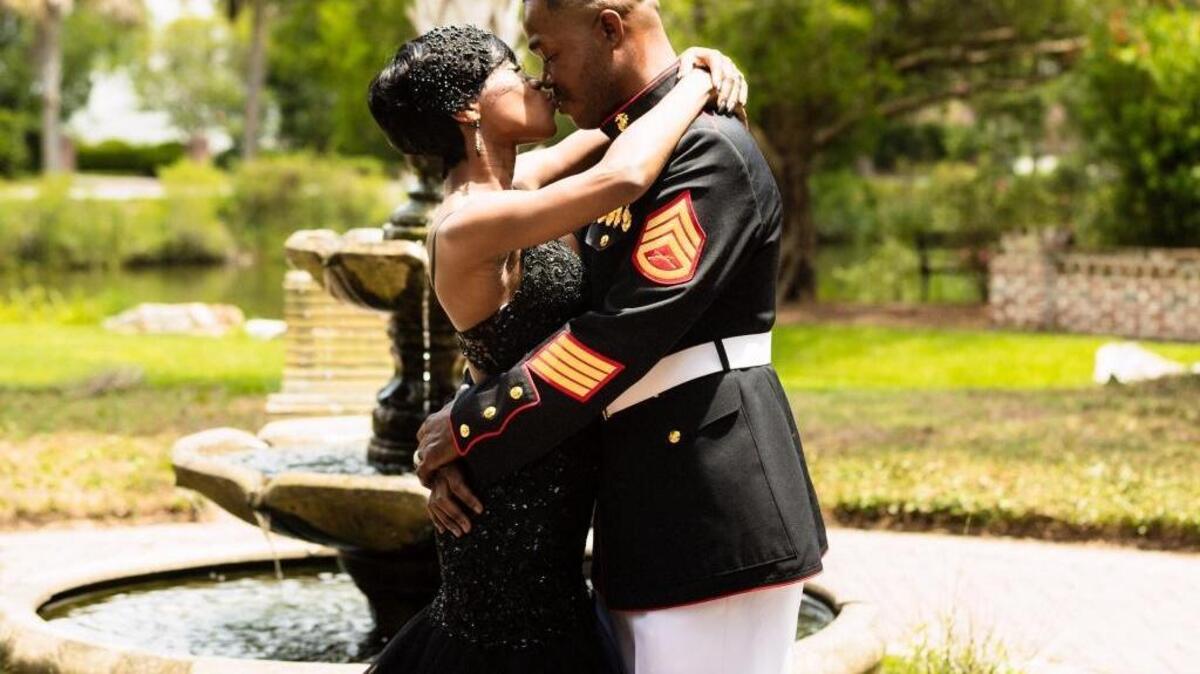 Nakita Brown and Rymario Armstrong share a kiss after exchanging vows and saying “I do” during a wedding ceremony planned as a surprise for Armstrong by Brown on July 4, 2017, in Old Point Park in Beaufort.