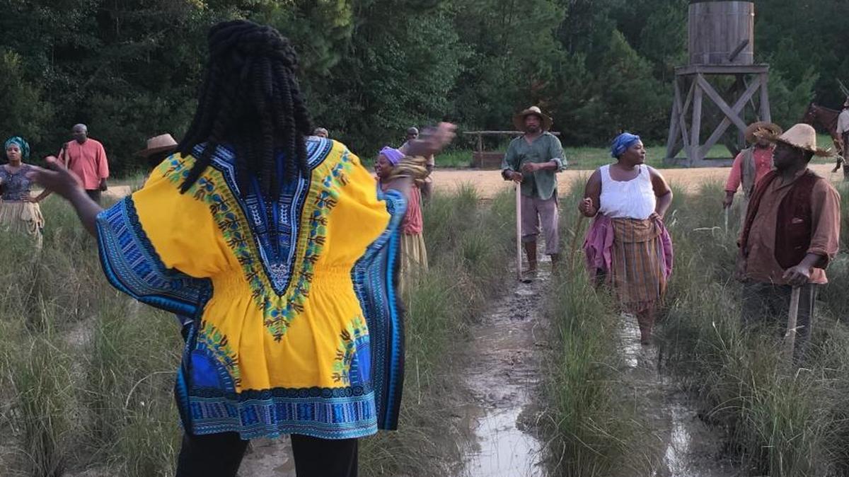 Marquetta Goodwine, also known as Queen Quet and chieftess of the Gullah-Geechee Nation, foreground, directs actors depicting slaves working a rice paddy during filming in Savannah for the second season of WGN’s “Underground.” The show is set on a slave plantation on a South Carolina island, and Goodwine, a St. Helena resident, was brought on as a consultant.