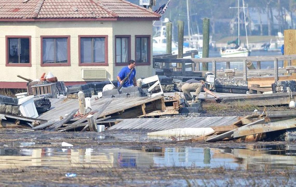 Workers assess the damage of docks at Palmetto Bay Marina on Hilton Head Island in 2016. The docks were destroyed by Hurricane Matthew, which hit the island on Oct. 8.