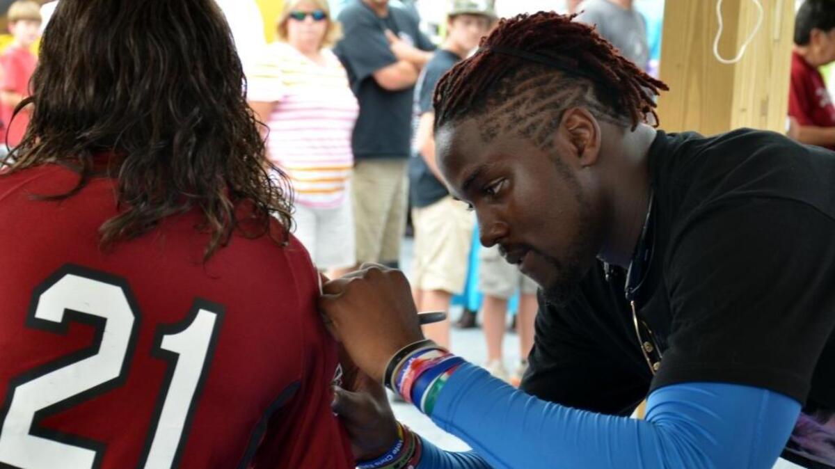 Devin Taylor signs his autograph during Devin Taylor Appreciation Day at Beaufort Town Square in 2013.