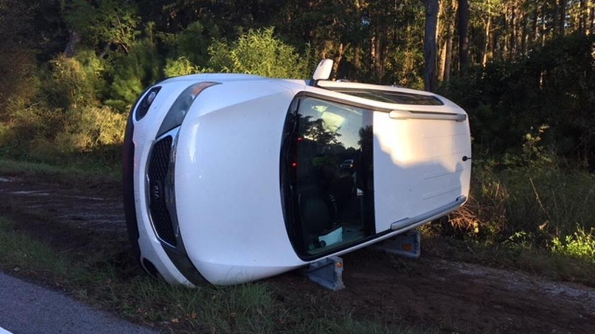 A woman and child got themselves out of a vehicle that landed on its side after a crash in Burton Wednesday morning. Both were uninjured.