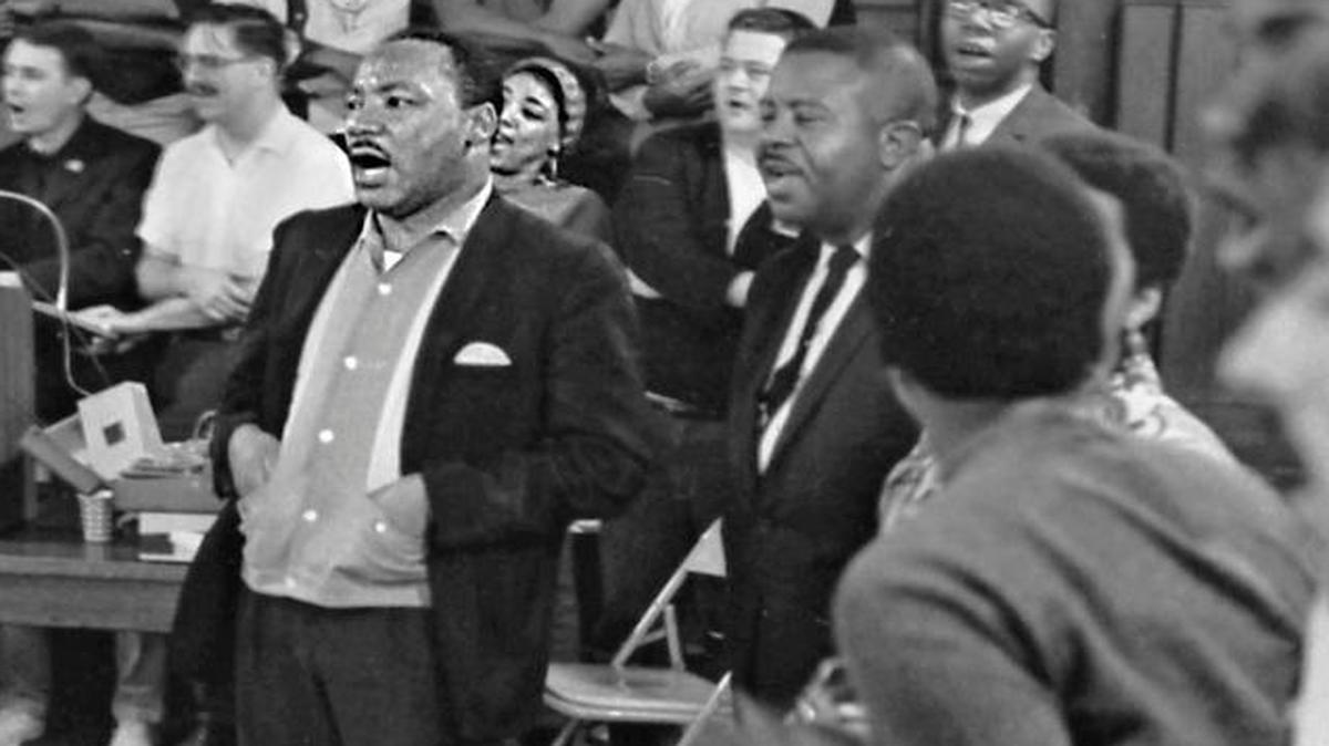 Martin Luther King Jr. singing, center, attends the annual Southern Christian Leadership Conference staff workshop held at the Penn Center on St. Helena Island in 1966.