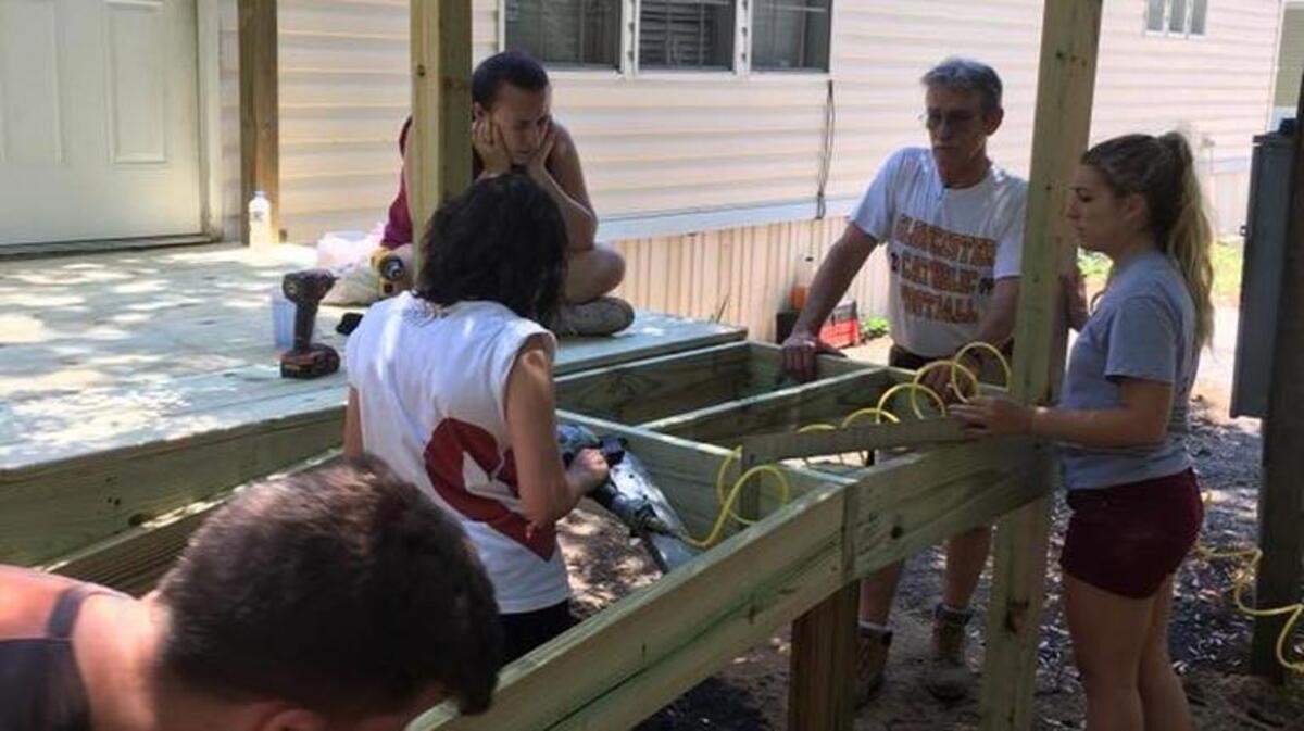 Volunteers with Catholic HEART Work Camp work to build a deck on a home. More than 350 volunteers worked on projects for Beaufort and Jasper county residents in need.
