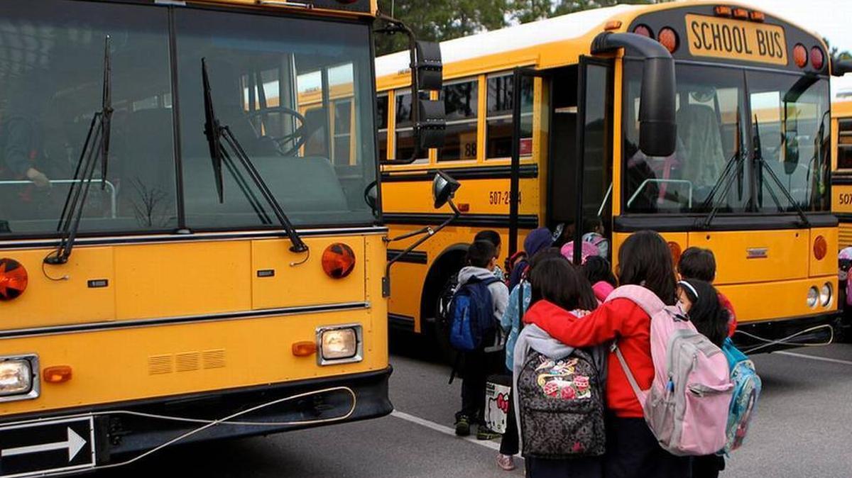 In this file photo, Red Cedar Elementary School students wait to board the school buses at the end of the school day at Red Cedar Elementary School in Bluffton.
