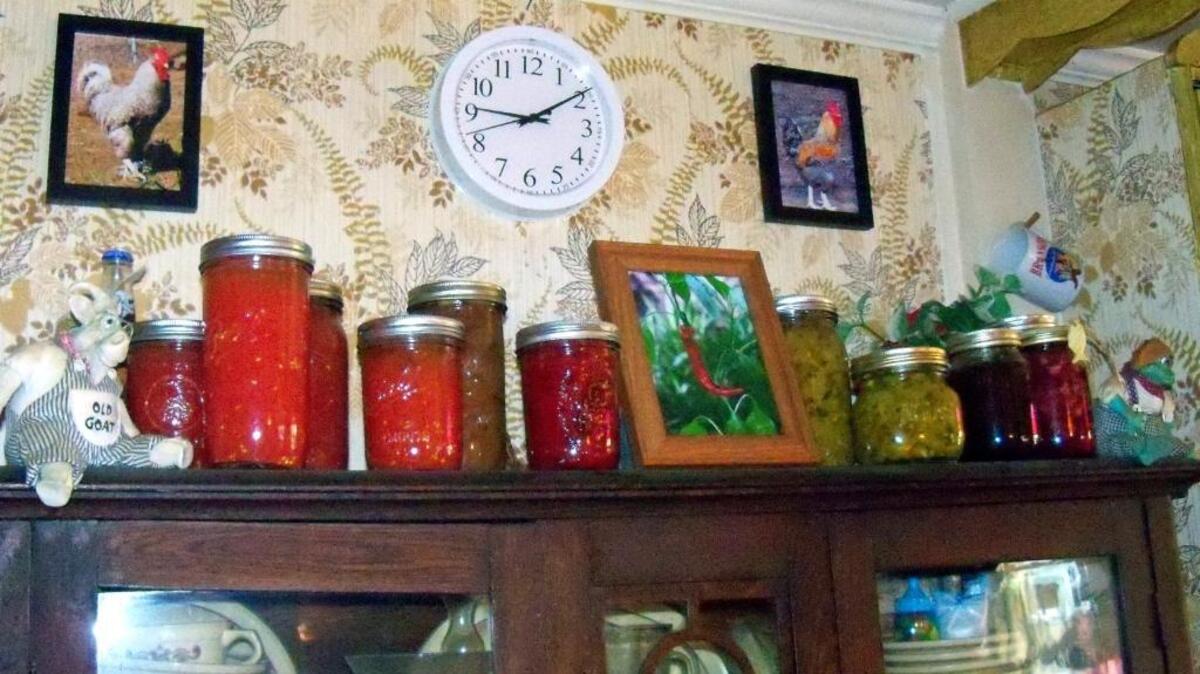 A shelf holds the fruits of a recent canning labor.