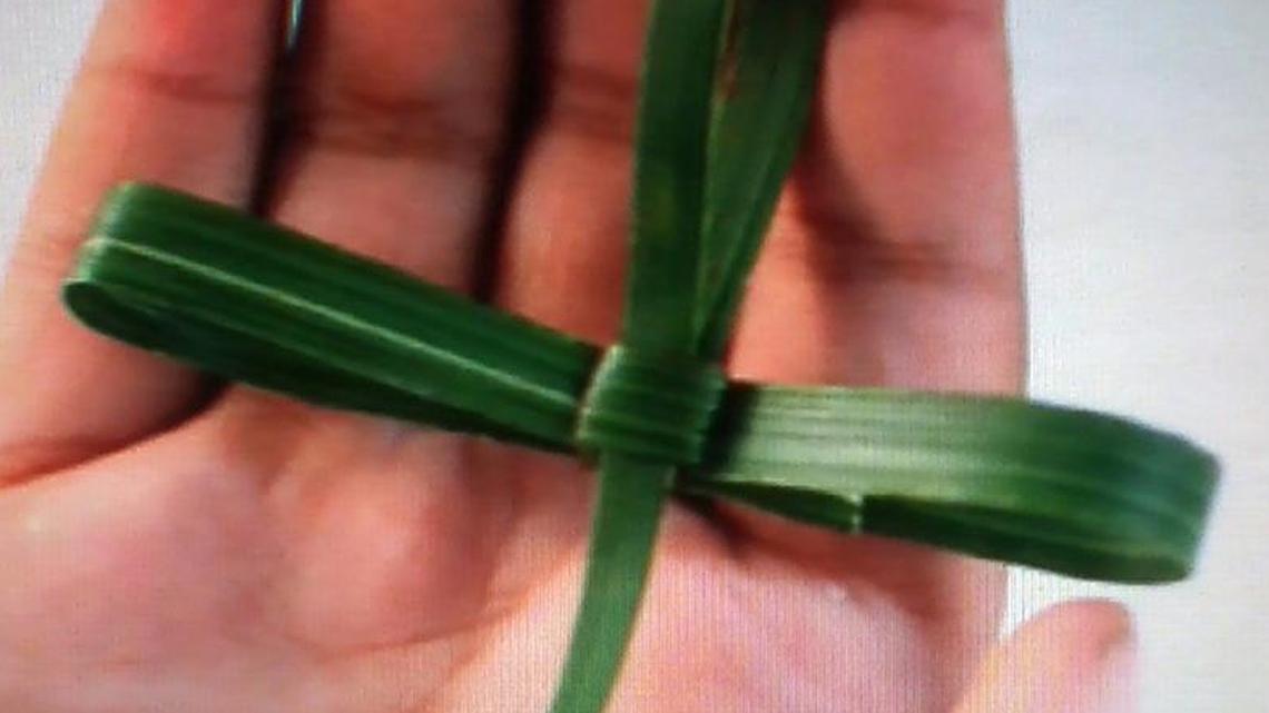 A tiny cross made from a palm branch can be pinned to a lapel on Easter morning.